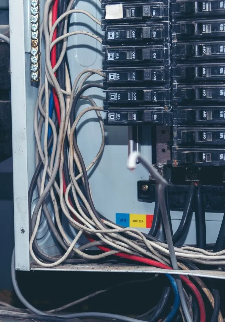 electrical-panel-with-wires-and-circuit-breakers-1920w Technician At Panel